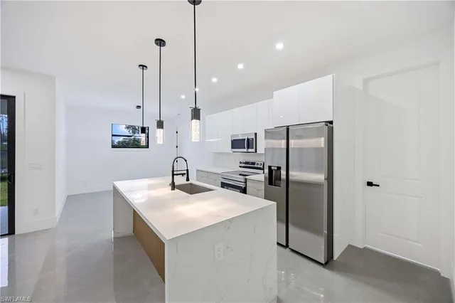 a kitchen with kitchen island sink stove and center island