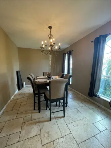 a dining room with furniture and window