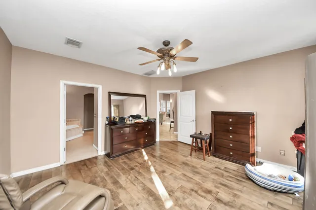 a spacious bathroom with a granite countertop sink a mirror and a