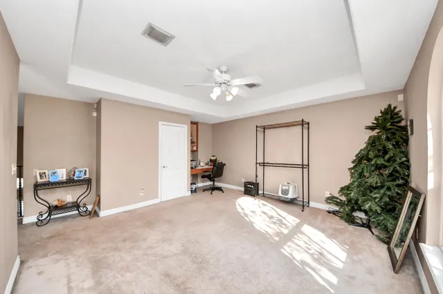 a view of a livingroom with a window and a kitchen