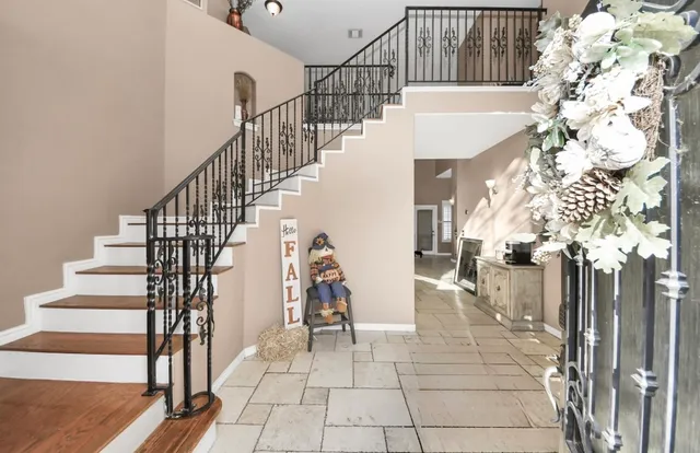 a view of entryway and hall with wooden floor