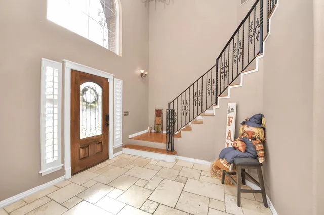 a view of entryway and hall with a front door