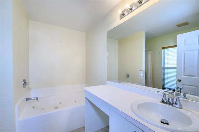 a bathroom with bathtub and shower