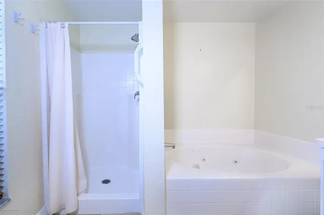 a bathroom with a granite countertop toilet a sink and shower