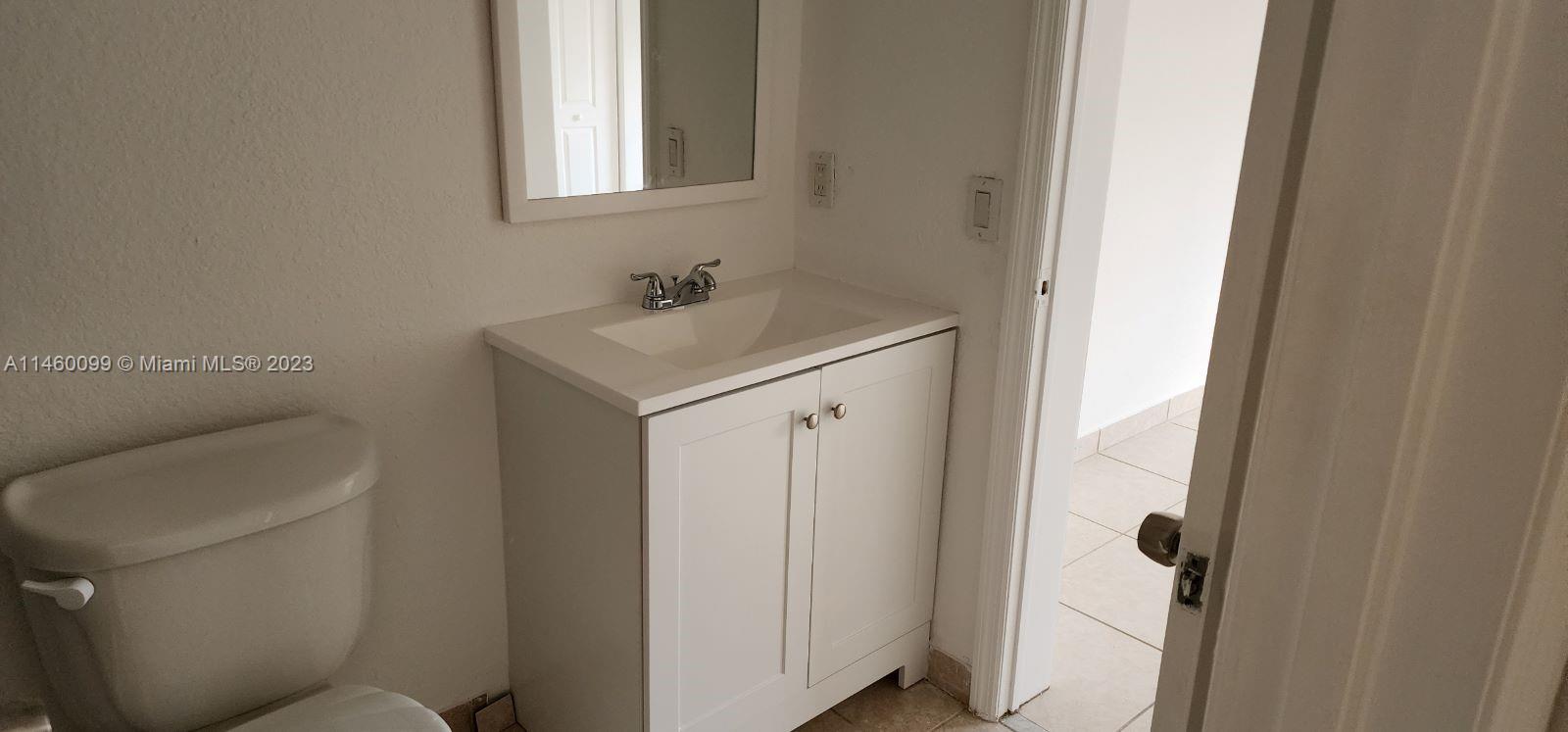 501 West 68th Street, Unit 4 Hialeah, FL 33014 - Photo 15 of 20 a bathroom with a sink toilet and vanity