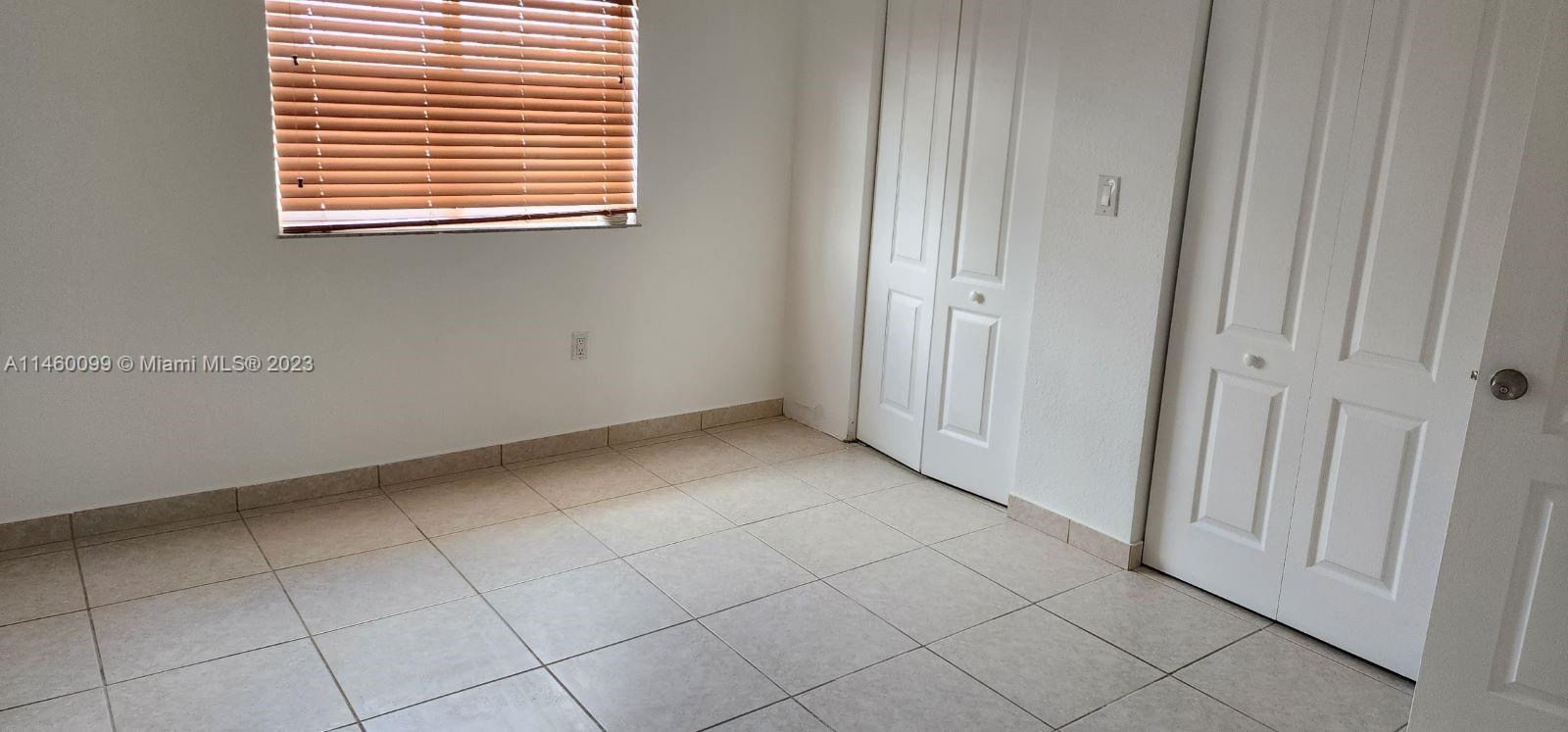 501 West 68th Street, Unit 4 Hialeah, FL 33014 - Photo 16 of 20 an empty room with a window
