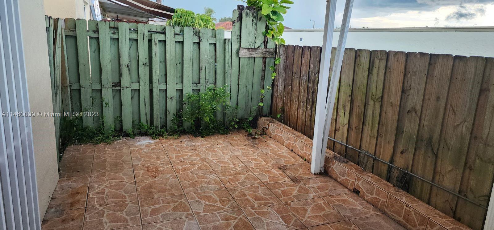 501 West 68th Street, Unit 4 Hialeah, FL 33014 - Photo 17 of 20 a view of a backyard with wooden fence