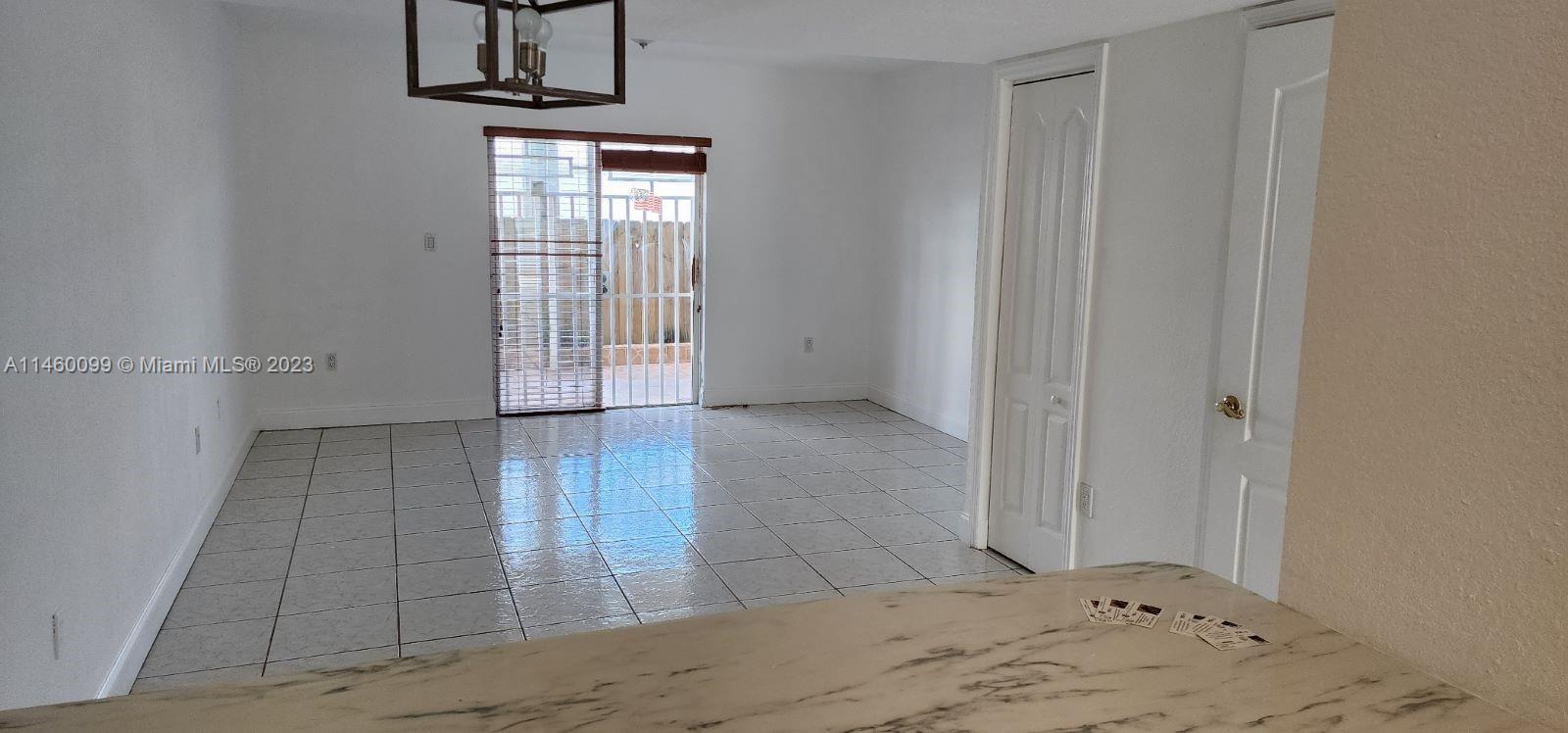 501 West 68th Street, Unit 4 Hialeah, FL 33014 - Photo 8 of 20 an empty room with wooden floor and windows