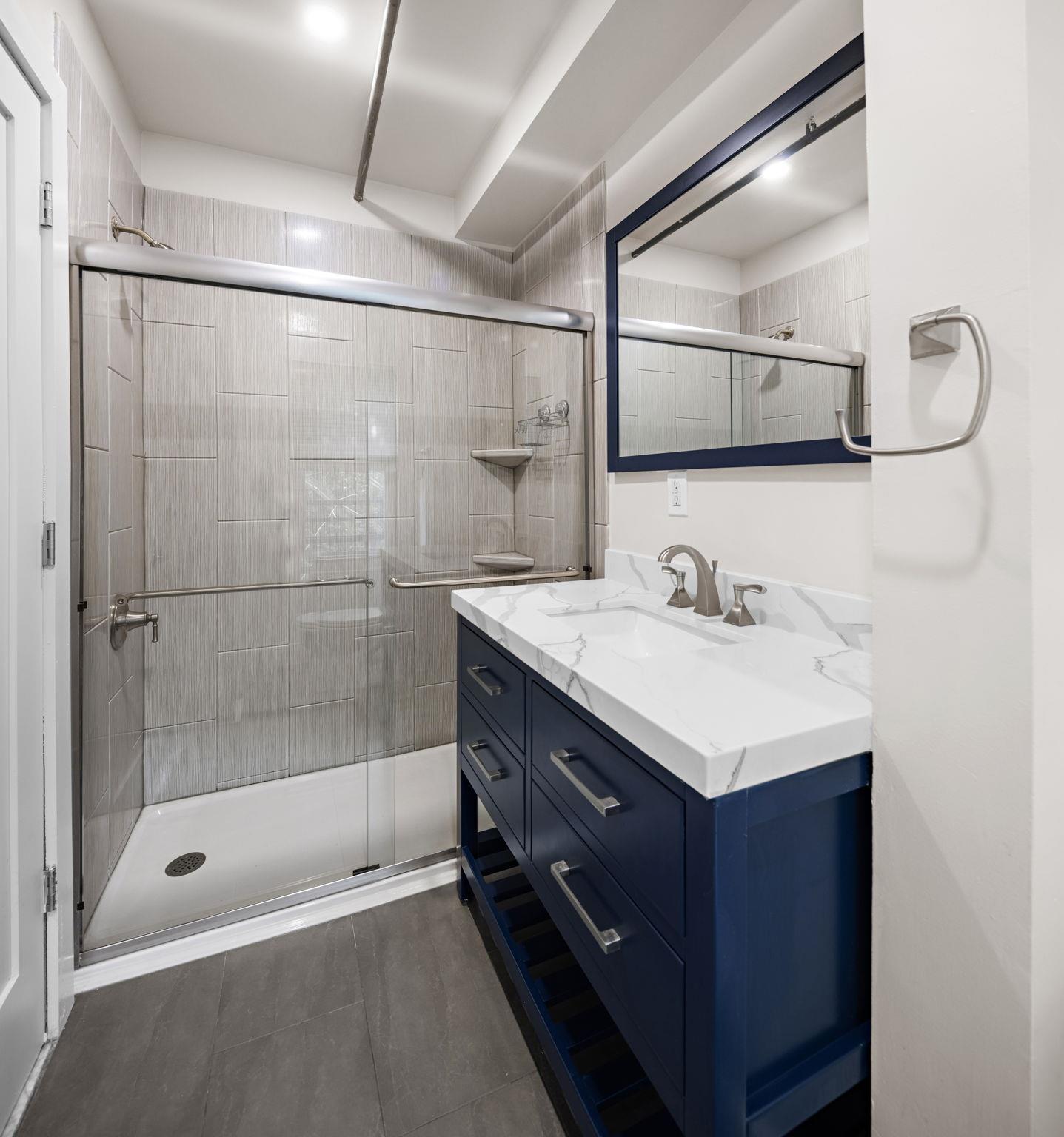 309 Monroe Street, Unit FIVE Hoboken, NJ 07030 - Photo 11 of 14 a bathroom with a bathtub shower sink vanity and mirror