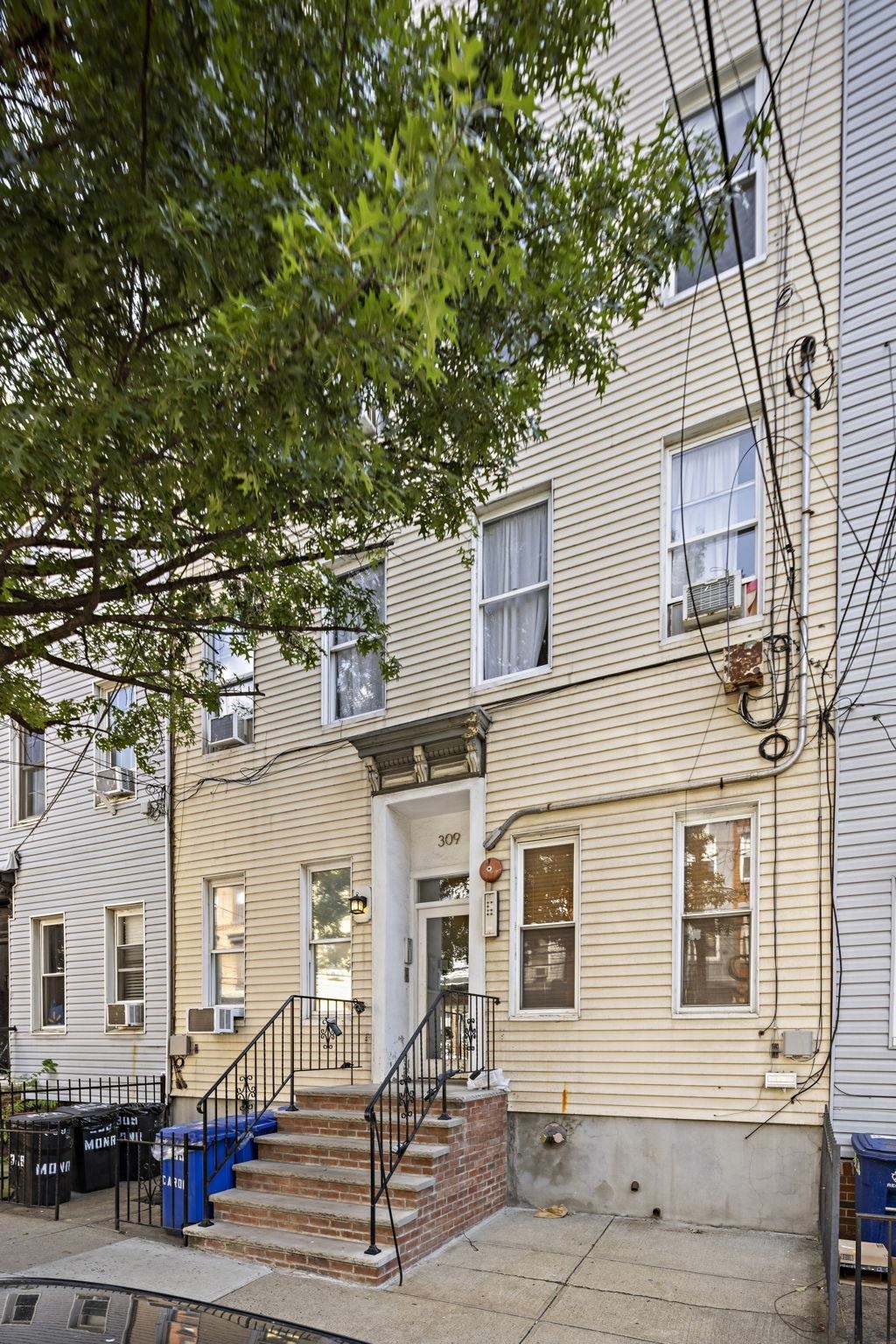 309 Monroe Street, Unit FIVE Hoboken, NJ 07030 - Photo 14 of 14 a front view of a house with a tree