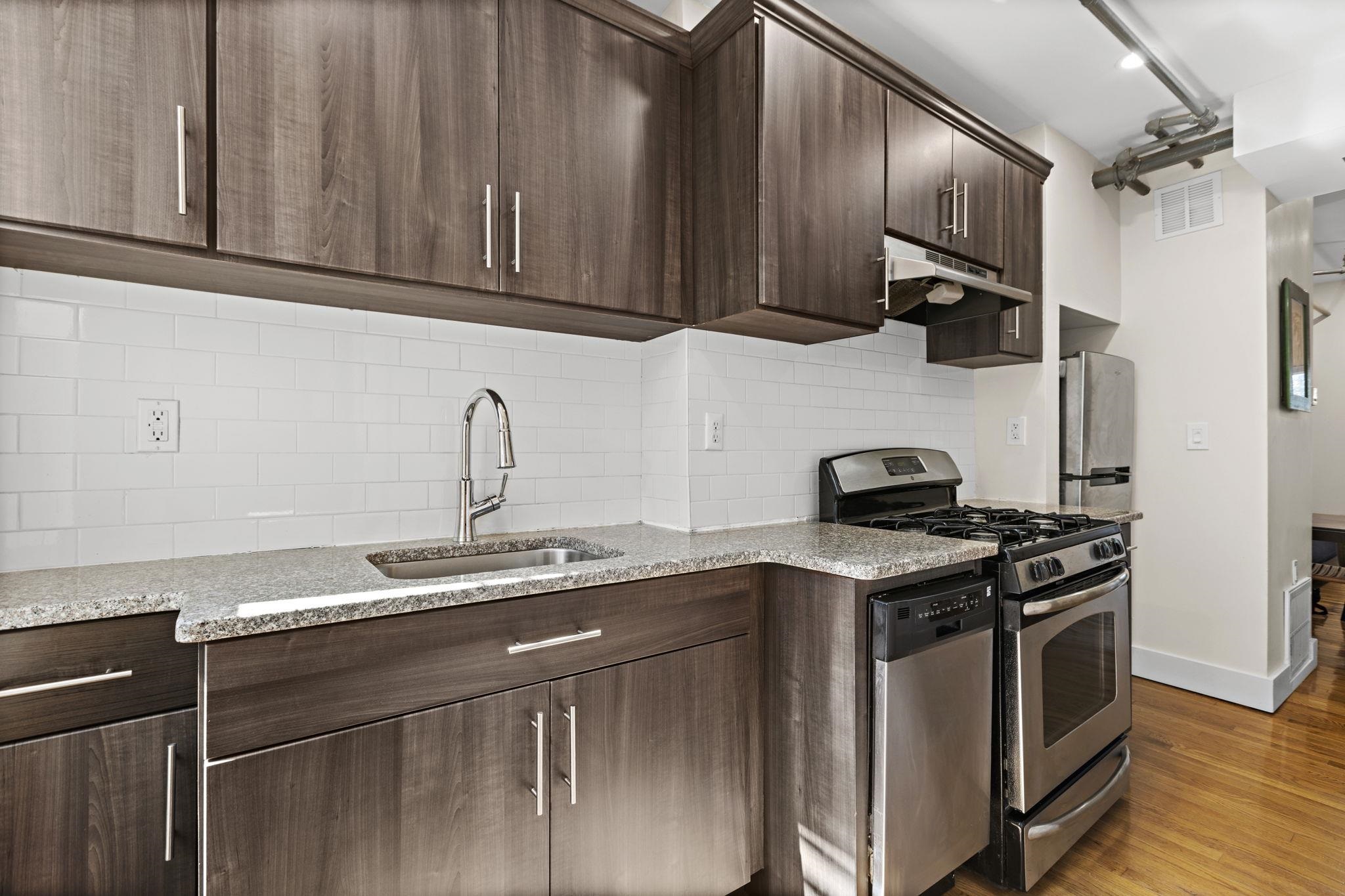 309 Monroe Street, Unit FIVE Hoboken, NJ 07030 - Photo 10 of 14 a kitchen with stainless steel appliances granite countertop a sink a stove and a microwave