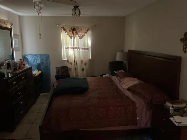 a bedroom with a bed and window