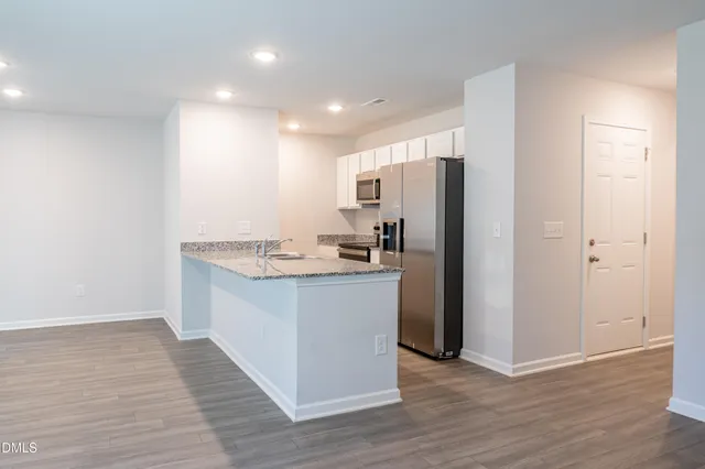 a kitchen with a refrigerator and a sink