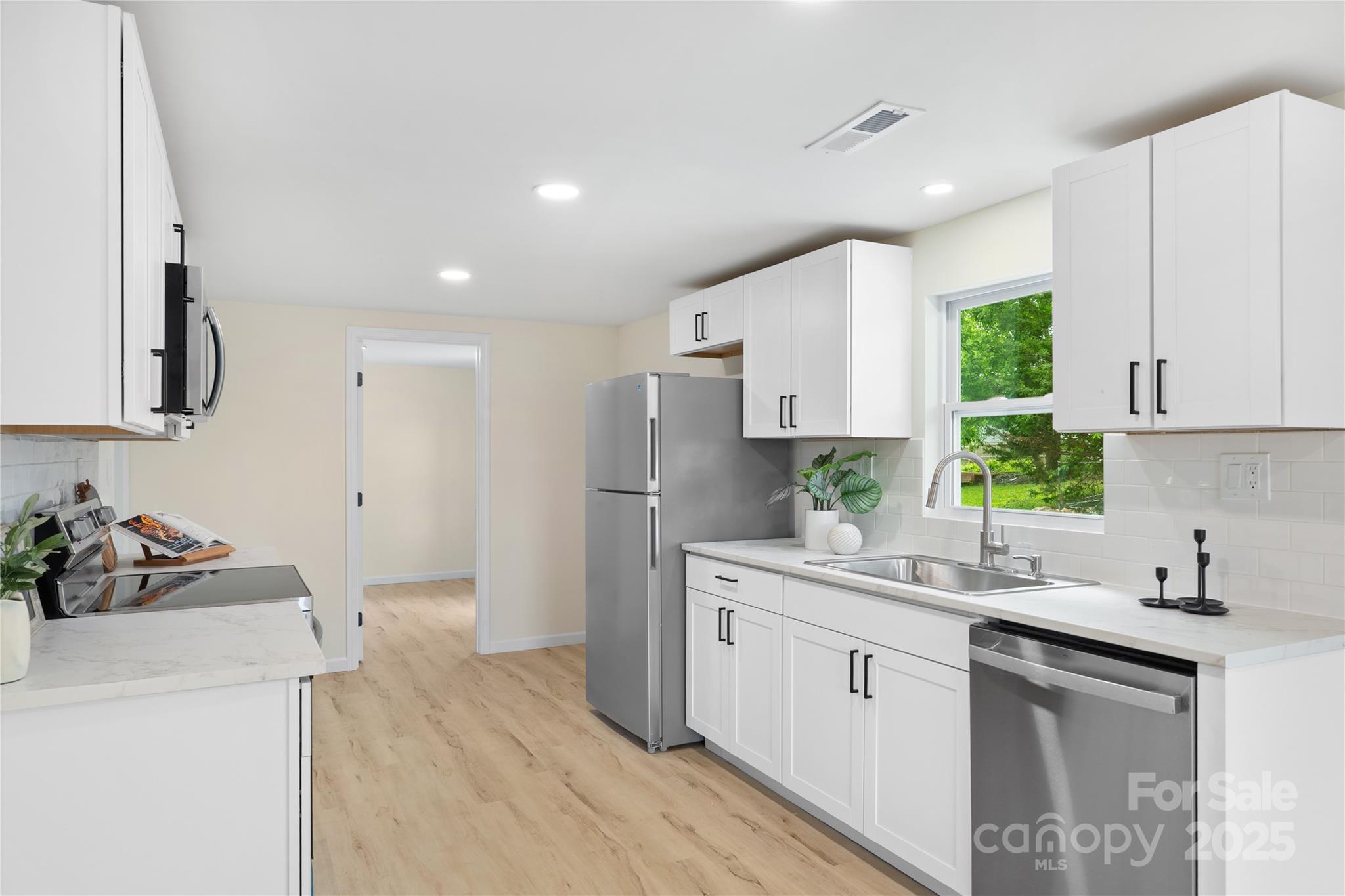 1574 Mangum Drive Lancaster, SC 29720 - Photo 11 of 22 a kitchen with a sink stove and cabinets