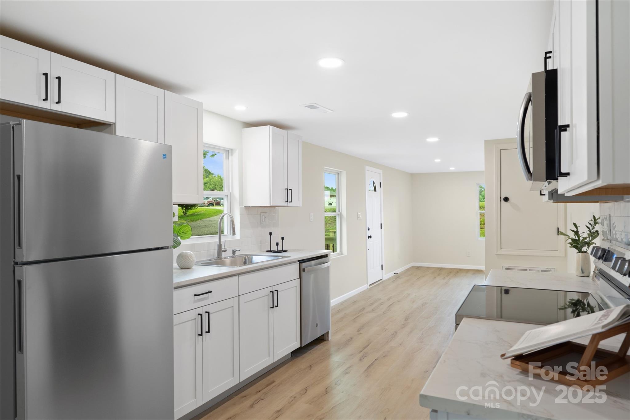 1574 Mangum Drive Lancaster, SC 29720 - Photo 13 of 22 a kitchen with a refrigerator sink and white cabinets