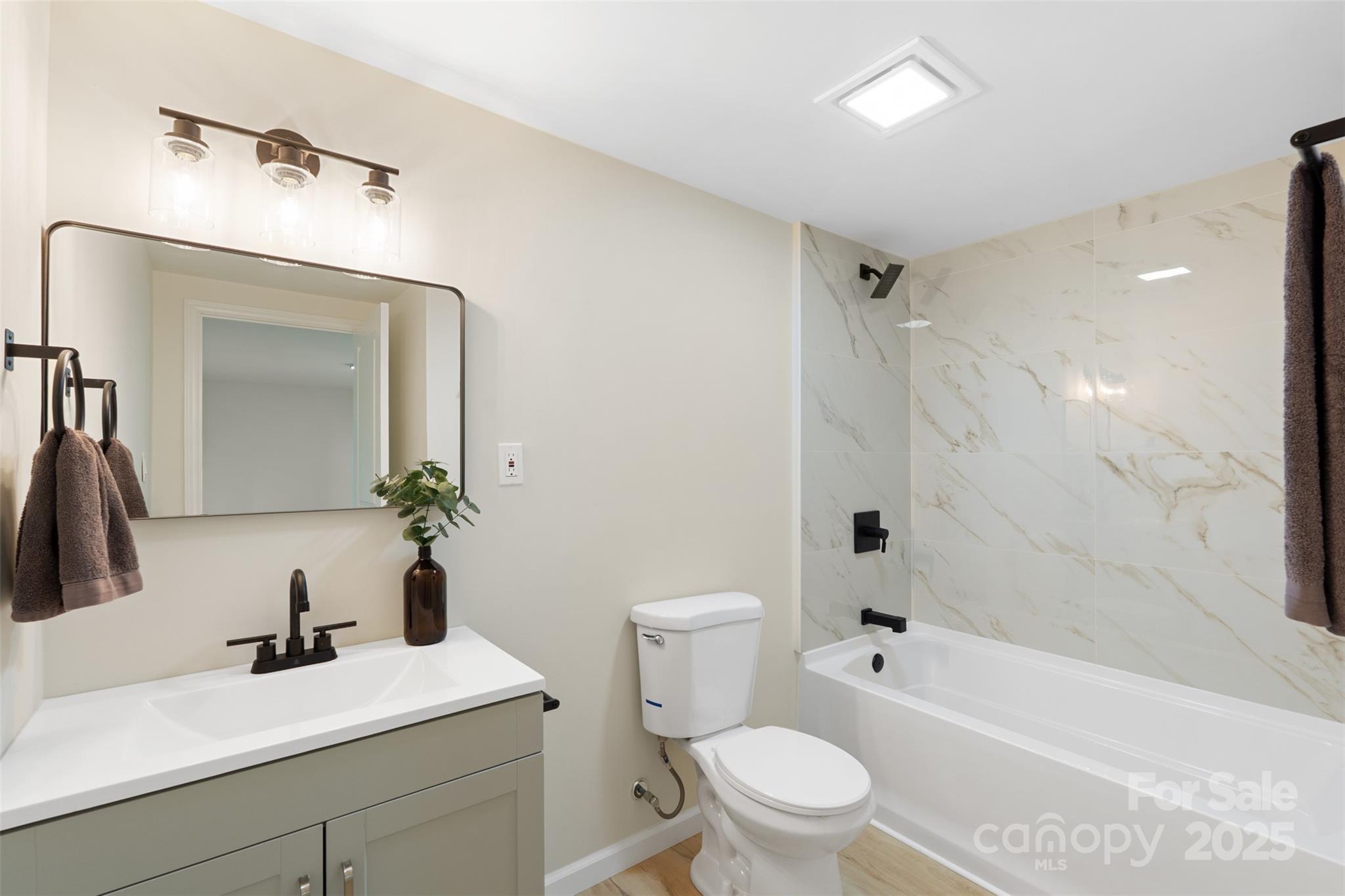 1574 Mangum Drive Lancaster, SC 29720 - Photo 15 of 22 a bathroom with a sink a toilet a tub and a mirror