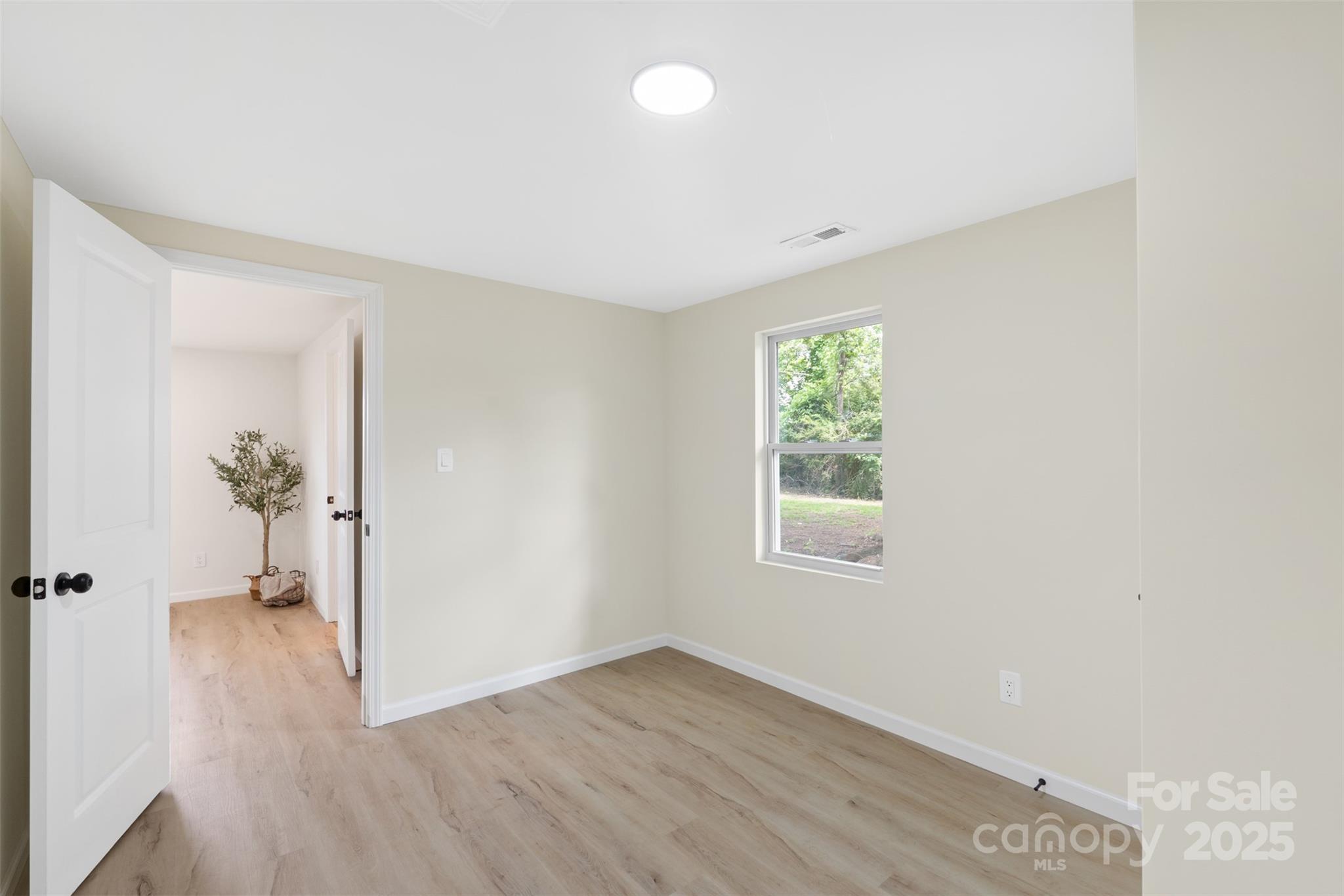 1574 Mangum Drive Lancaster, SC 29720 - Photo 16 of 22 an empty room with wooden floor and windows