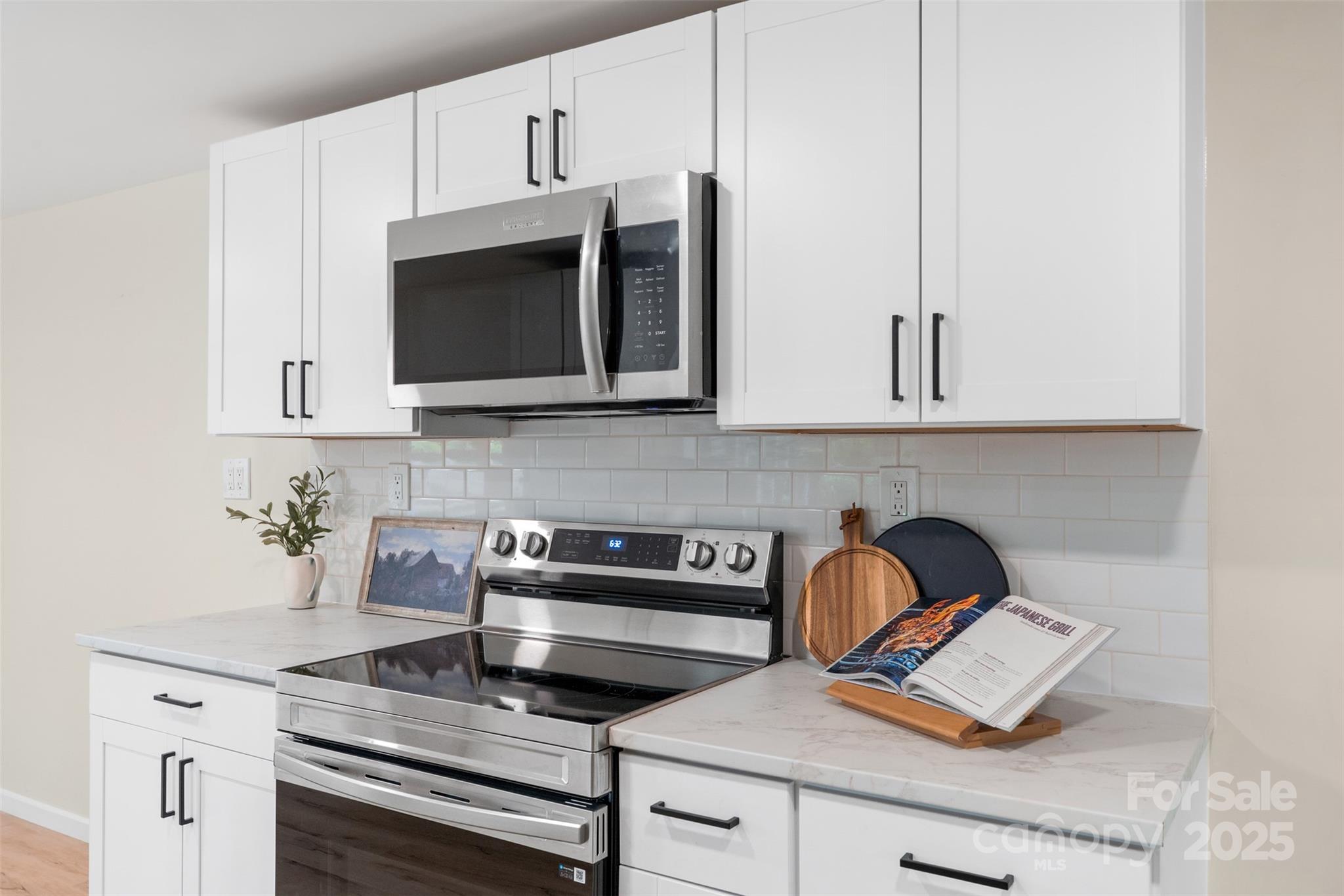 1574 Mangum Drive Lancaster, SC 29720 - Photo 10 of 22 a kitchen with stainless steel appliances granite countertop white cabinets stove top oven and sink