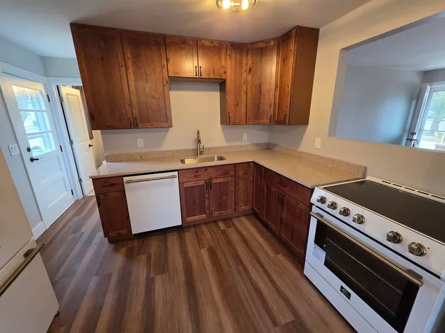 a kitchen with wooden floors and a sink