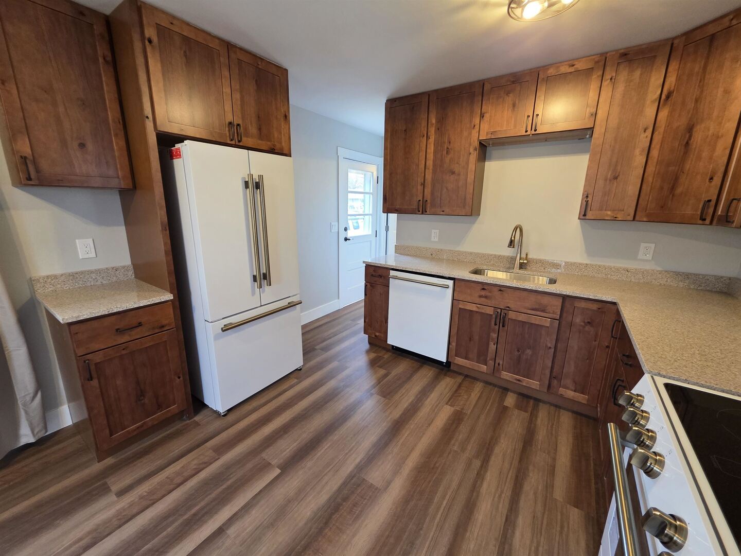 1206 10th Avenue North Clinton, IA 52732 - Photo 13 of 27 a kitchen with wooden floors and white appliances