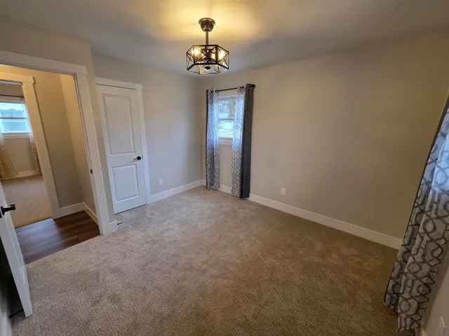 an empty room with windows and entrance