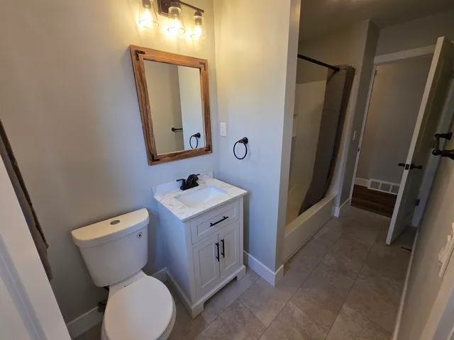 a view of a chair and tables in the balcony