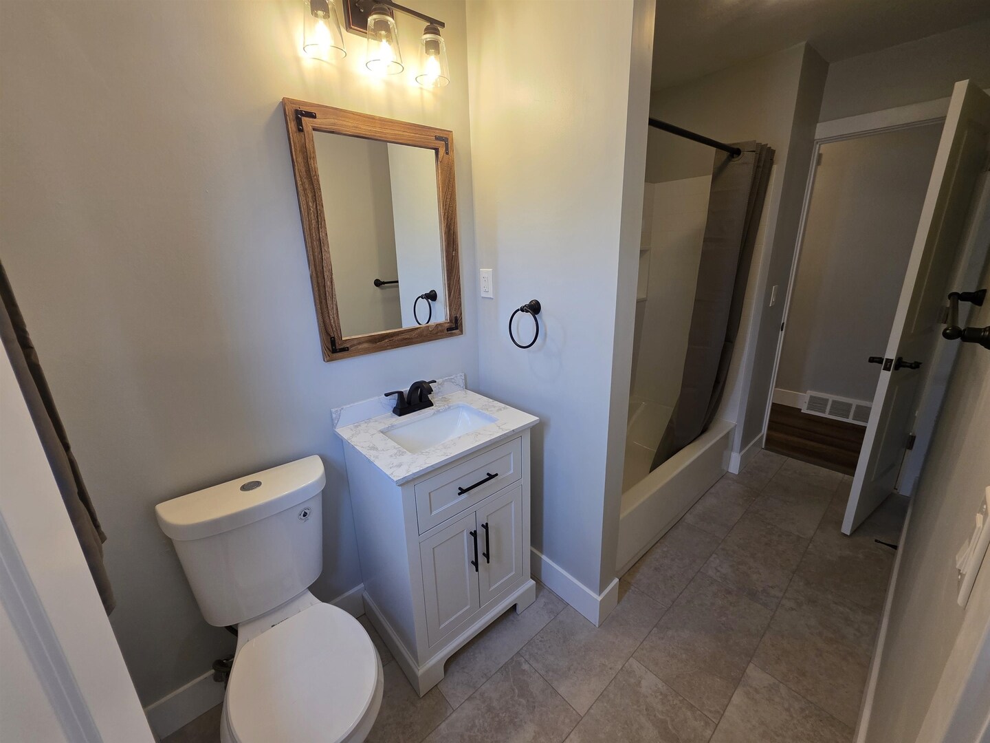 1206 10th Avenue North Clinton, IA 52732 - Photo 24 of 27 a bathroom with a toilet sink and mirror