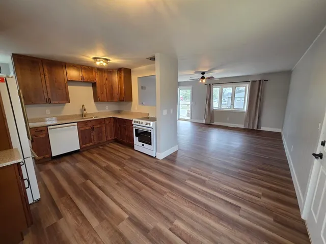 a view of kitchen with sink and refrigerator