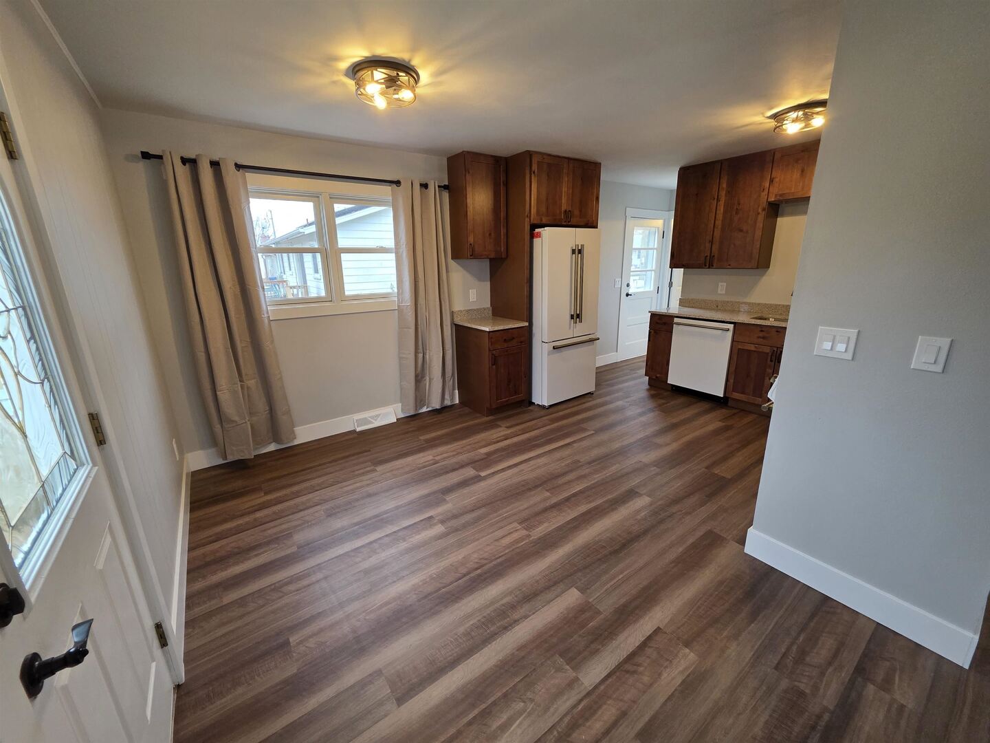 1206 10th Avenue North Clinton, IA 52732 - Photo 7 of 27 a kitchen with stainless steel appliances a refrigerator cabinets and wooden floor