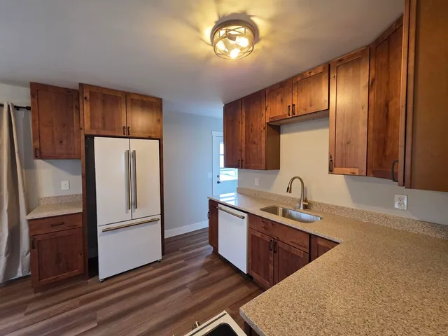 a kitchen with stainless steel appliances granite countertop a refrigerator a sink and dishwasher