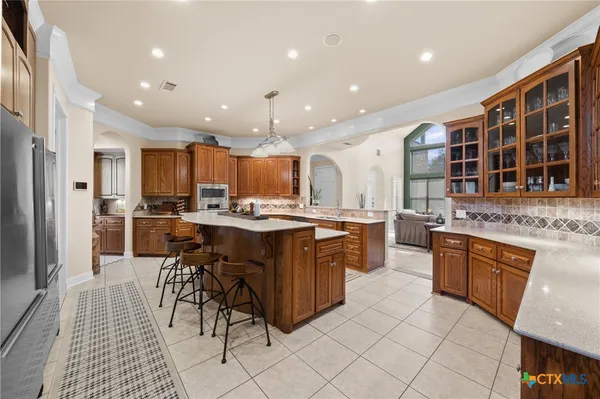 a kitchen with a sink stove and cabinets