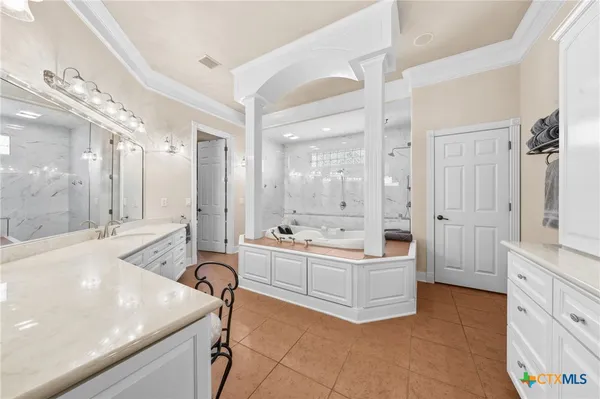 a spacious bathroom with a tub sink shower and mirror
