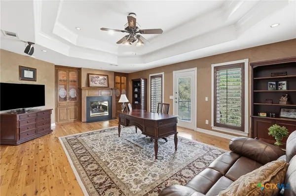 a bedroom with a bed and painting on the wall