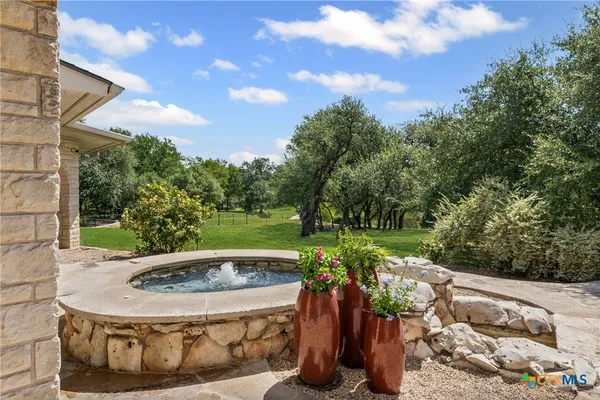 an aerial view of a house with yard and outdoor seating