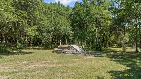 an aerial view of a house with a yard and lake view