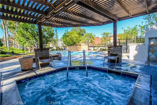 a view of a patio with table and chairs potted plants with wooden floor and floor to ceiling window