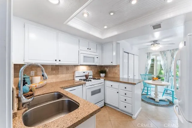 a kitchen that has a sink and cabinets
