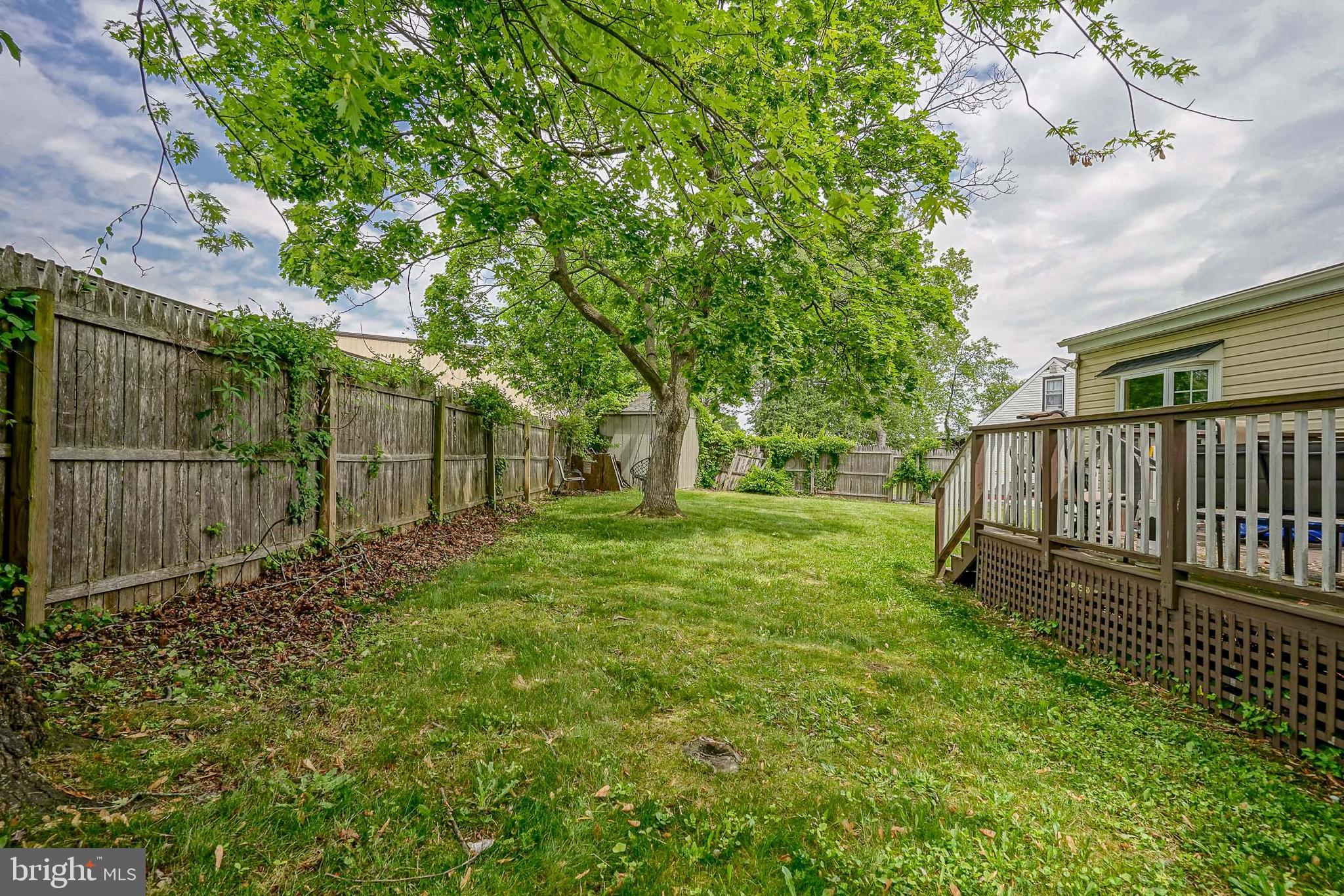 35 St Charles Place Runnemede, NJ 08078 - Photo 29 of 32 a view of a backyard with wooden fence and a bench