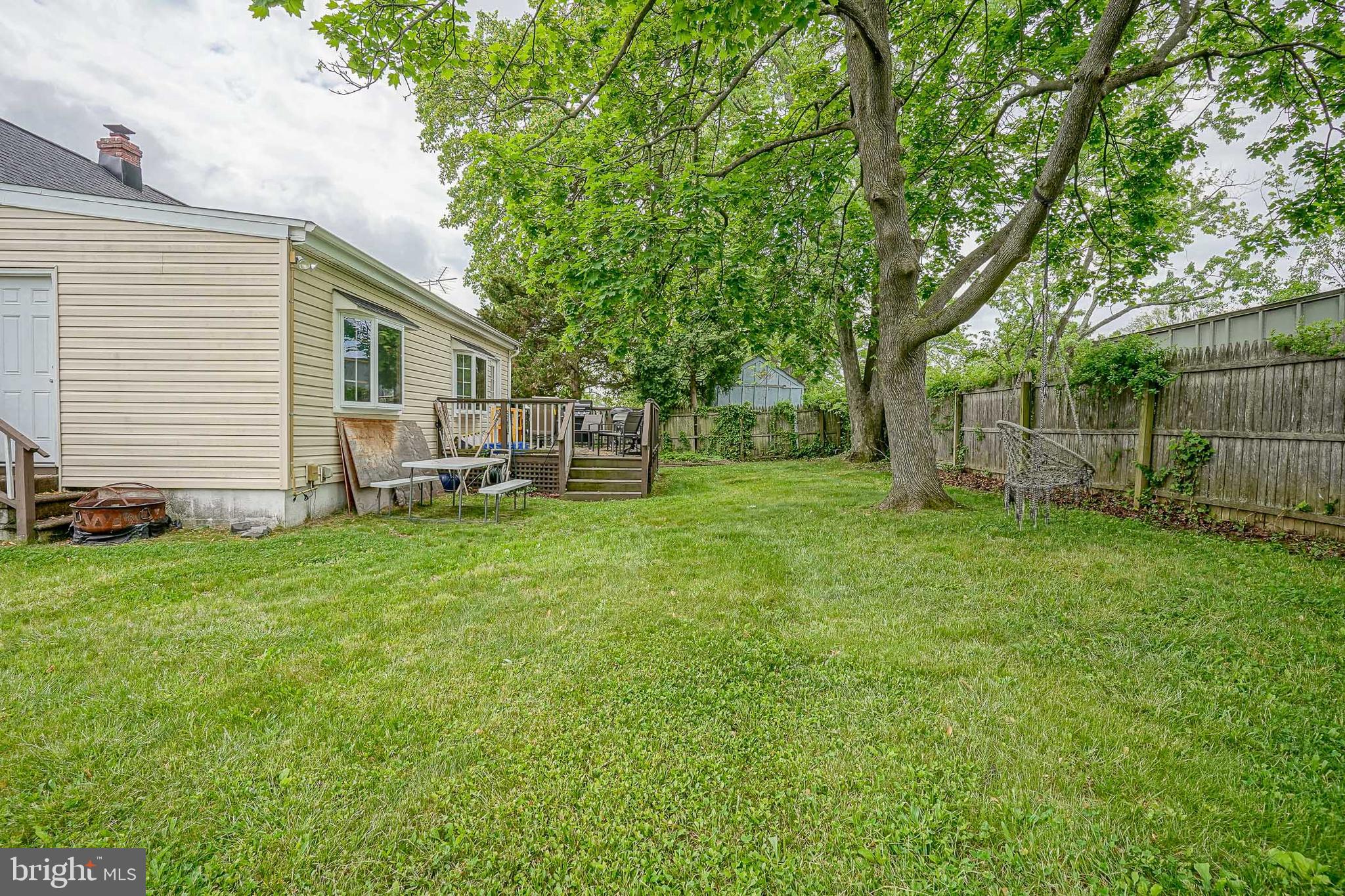 35 St Charles Place Runnemede, NJ 08078 - Photo 30 of 32 a view of a backyard with table and chairs and a large tree