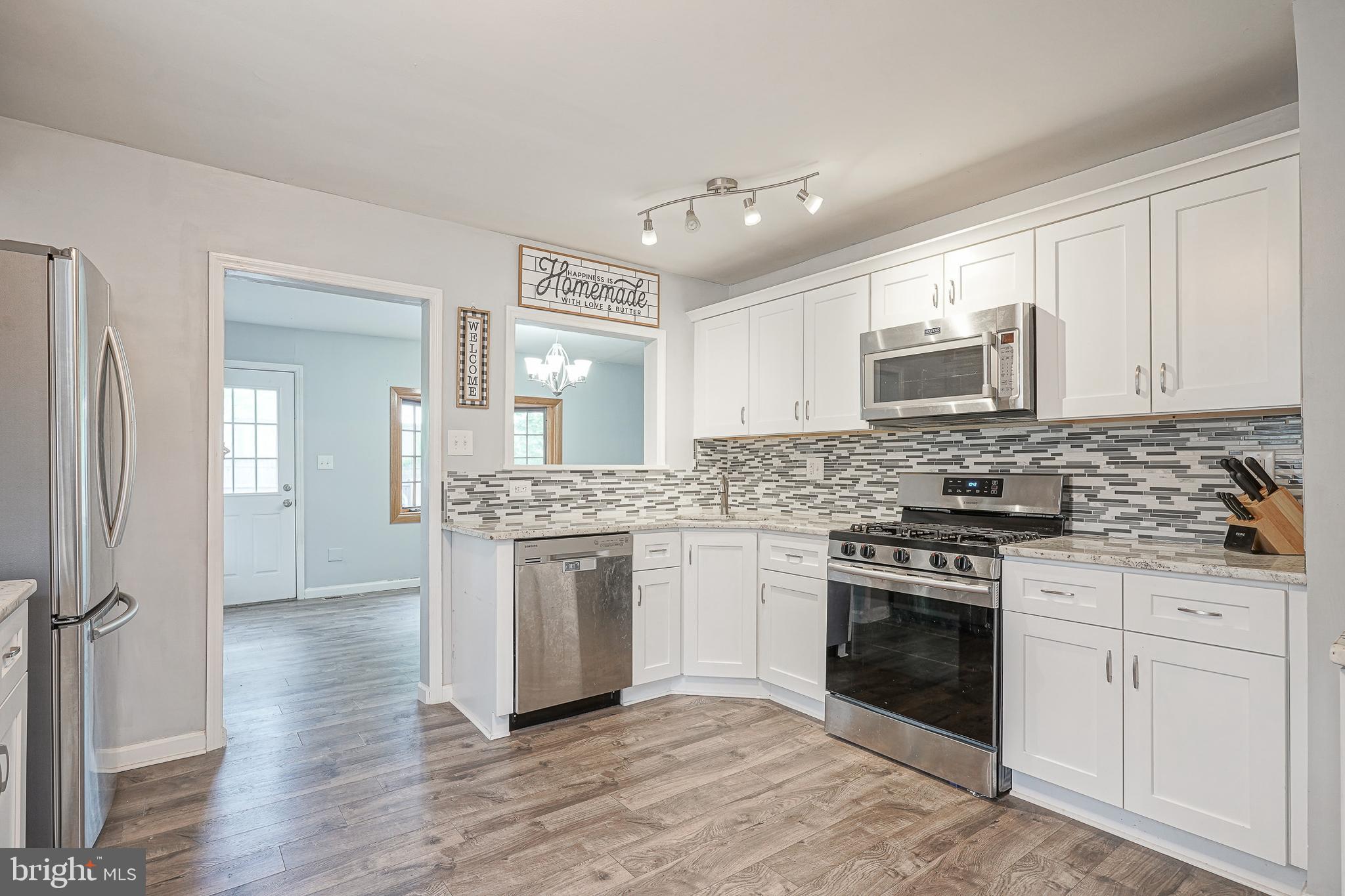 35 St Charles Place Runnemede, NJ 08078 - Photo 6 of 32 a kitchen with stainless steel appliances granite countertop a stove and a sink