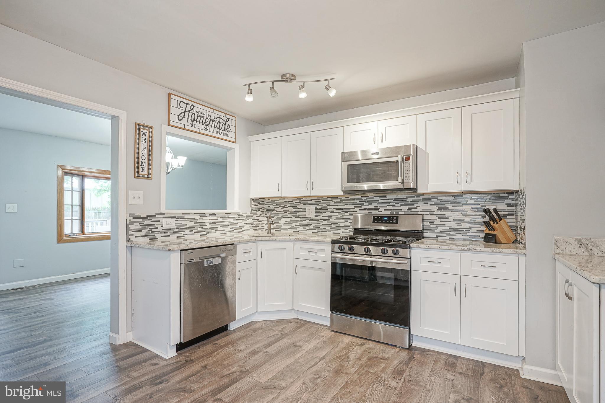 35 St Charles Place Runnemede, NJ 08078 - Photo 7 of 32 a kitchen with stainless steel appliances granite countertop a stove and a sink