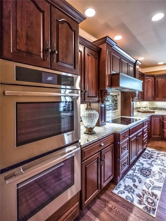 121 Buckthorn Drive Baden, PA 15005 - Photo 11 of 25 Beautiful cherry cabinetry with soft close drawers and roll outs, honed Travertine back splash & Jennaire frig, dbl convection ovens, 5 burner induction cooktop.