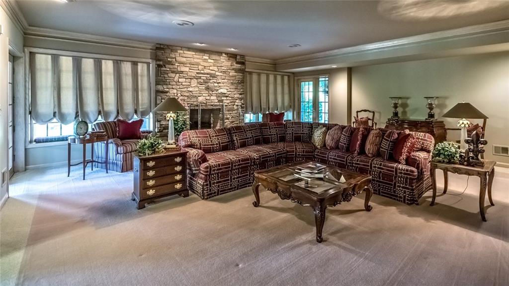 121 Buckthorn Drive Baden, PA 15005 - Photo 22 of 25 Huge finished lower level with tons of natural light includes this game area with walk behind bar & fireplace, billiards room, exercise room, separate play room, plus full bath w/changing area and huge laundry.