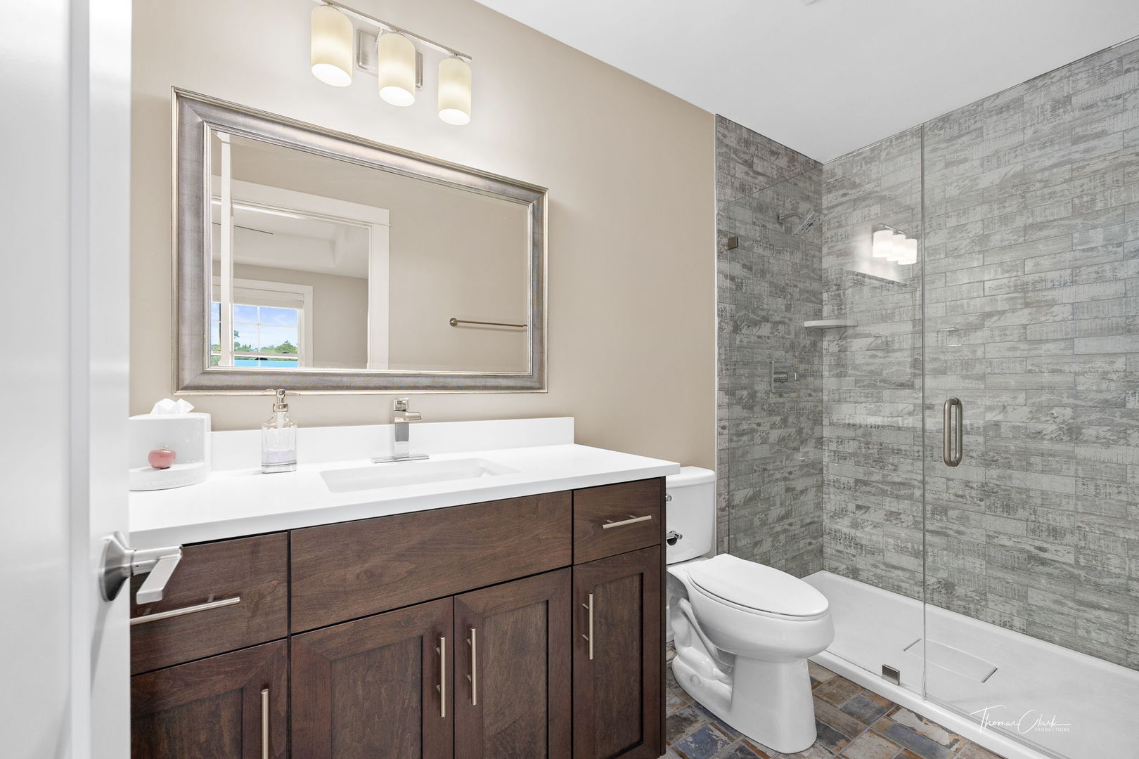 4720 Cumnor Road Downers Grove, IL 60515 - Photo 33 of 57 a bathroom with a toilet a sink a mirror and a shower