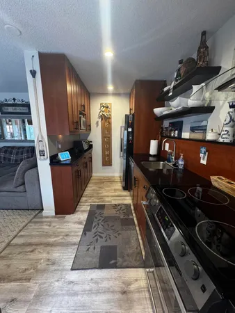 a kitchen with stainless steel appliances granite countertop a stove and a refrigerator