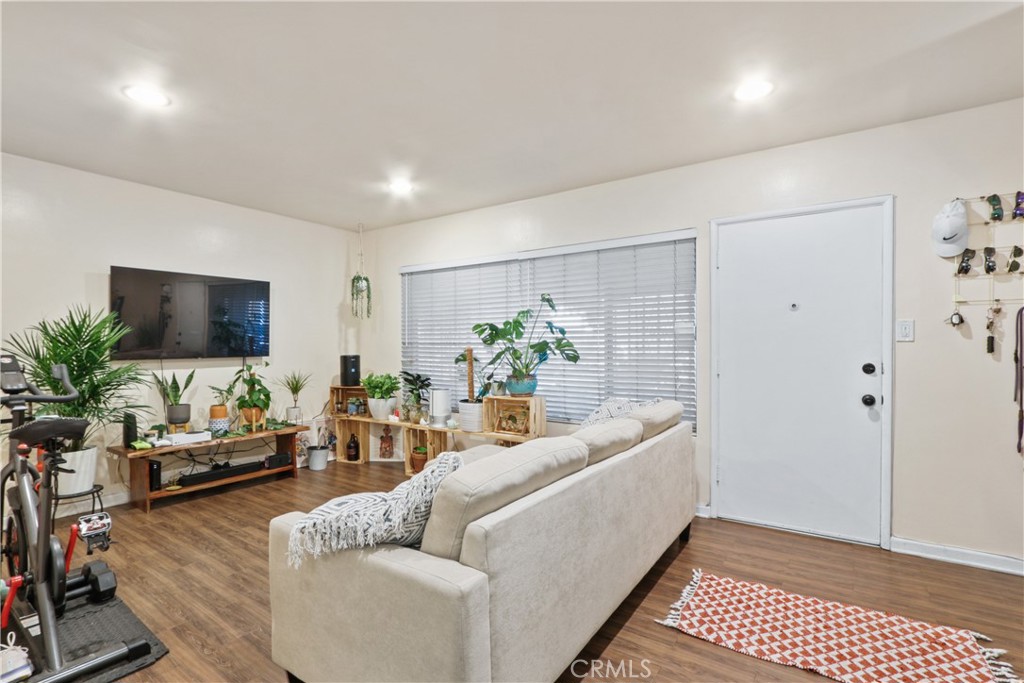 939 East Appleton Street, Unit 25 Long Beach, CA 90802 - Photo 2 of 10 a living room with furniture and a flat screen tv