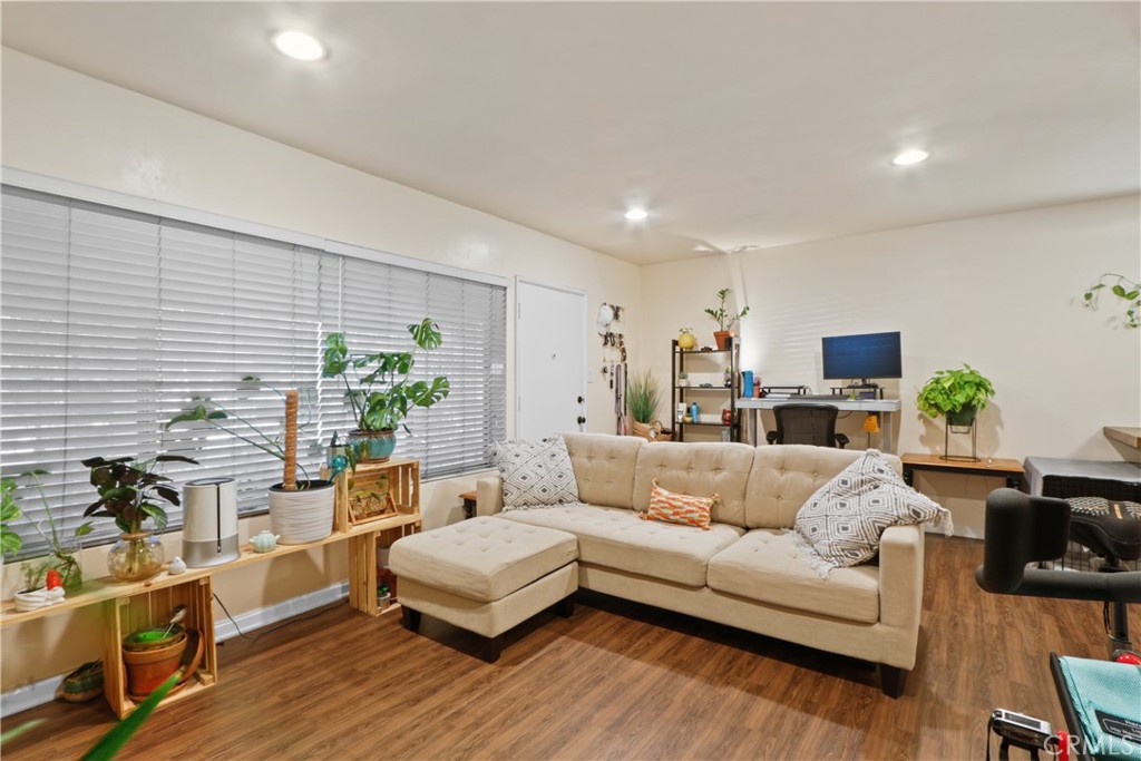 939 East Appleton Street, Unit 25 Long Beach, CA 90802 - Photo 5 of 10 a living room with furniture a flat screen tv and a potted plant