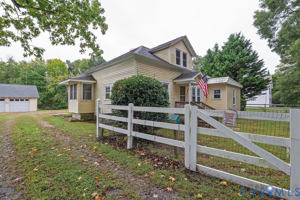 1881 Fairport Road Reedville, VA 22539 - Photo 47 of 54 Yellow siding exterior with white trim, a covered