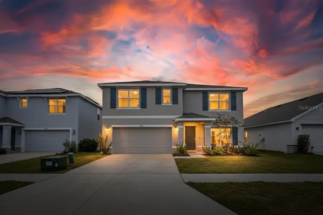 a front view of a house with a yard and garage