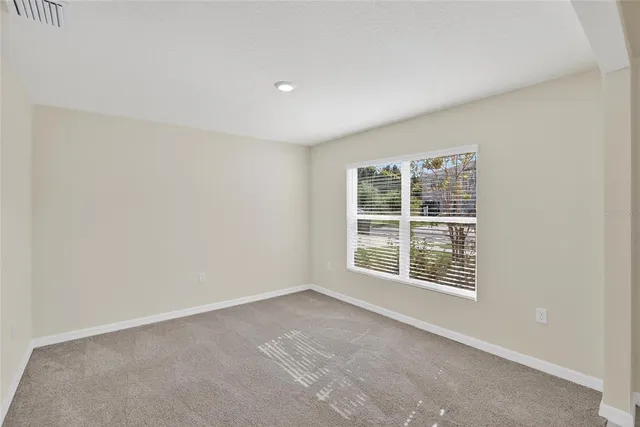 a large kitchen with stainless steel appliances granite countertop a stove a refrigerator a sink and dishwasher with wooden floor